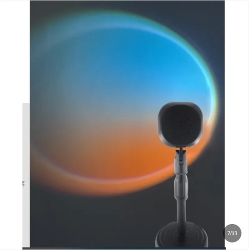 Aurora Sunset Projector Lamp casting a large orange and blue sunset circle across a wall